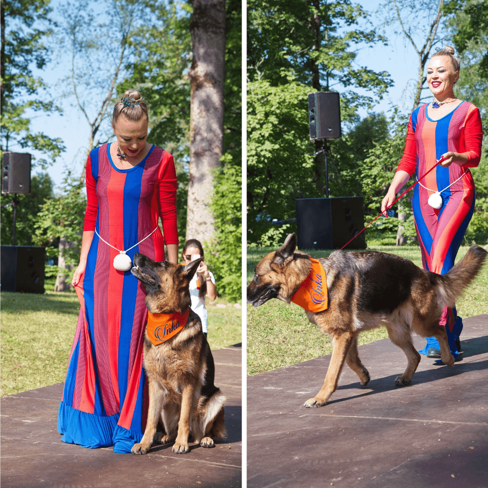 Model wearing the BETOLLI Inka Lady maxi dress with red, blue and orange vertical stripes, red three-quarter sleeves and a blue ruffle hem.