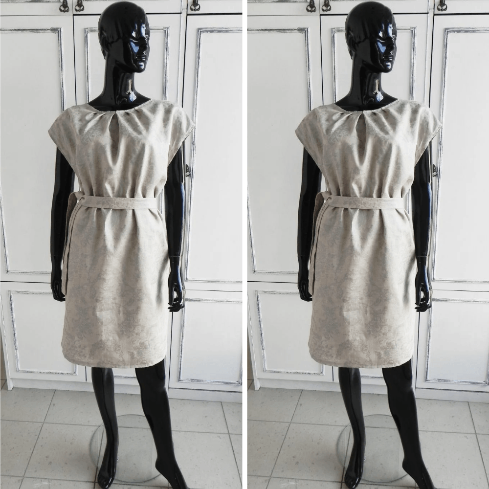 BETOLLI Natural beige linen dress with cap sleeves, neckline pleats, a matching waist belt and subtle silver-tone print, displayed on a mannequin.