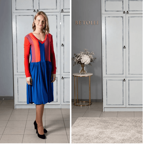 Model wearing the BETOLLI Orange Lady dress with an orange, coral and blue colour block bodice, long orange sleeves and a gathered blue skirt.