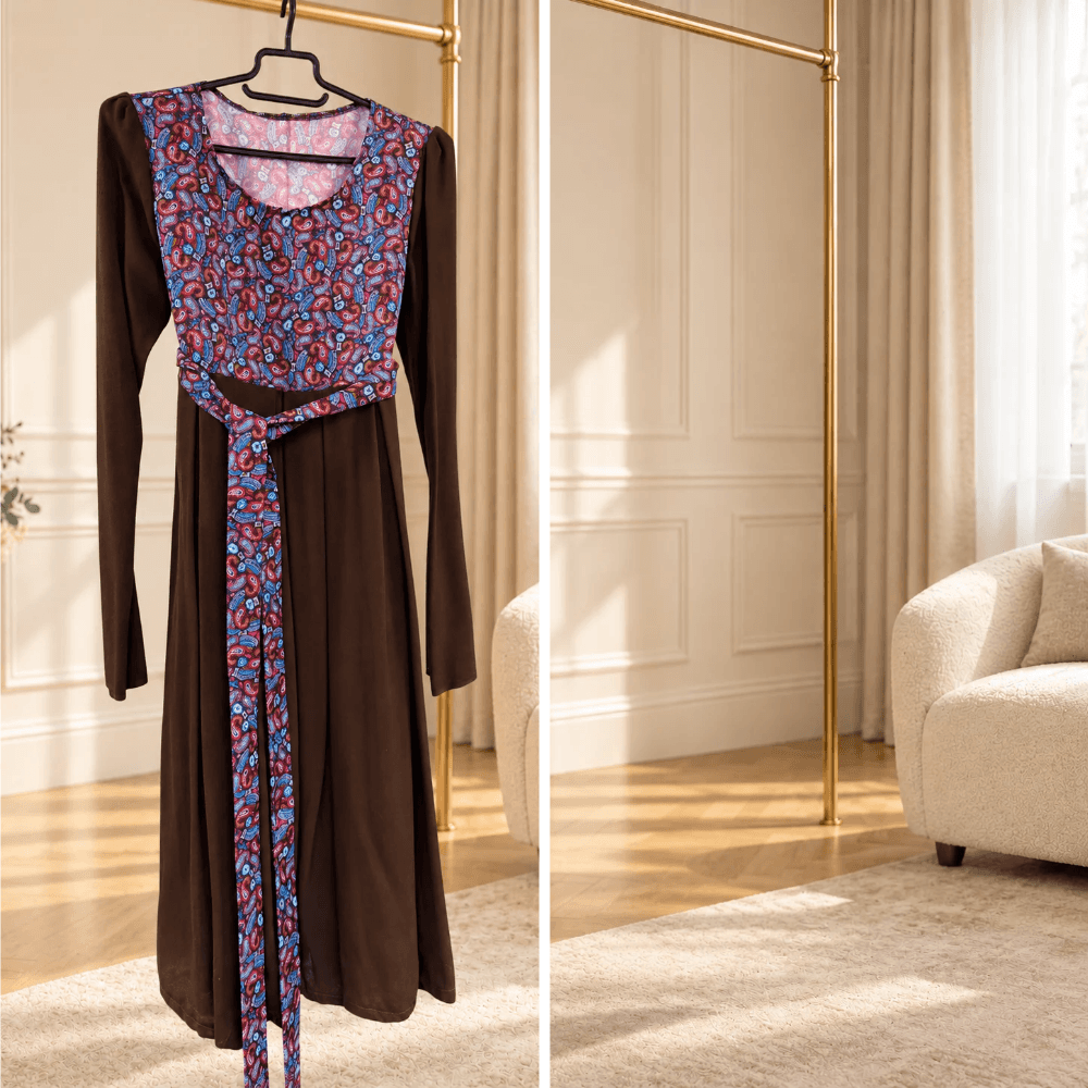 BETOLLI chocolate brown dress with long sleeves, a colourful patterned bodice, matching waist ties and a full skirt, displayed on a hanger.