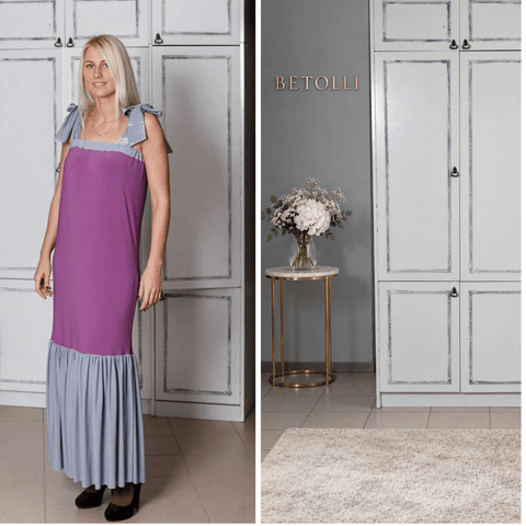 BETOLLI Sharm purple maxi dress with grey tie shoulder straps, a grey neckline and a wide gathered grey ruffle hem, worn by a model.