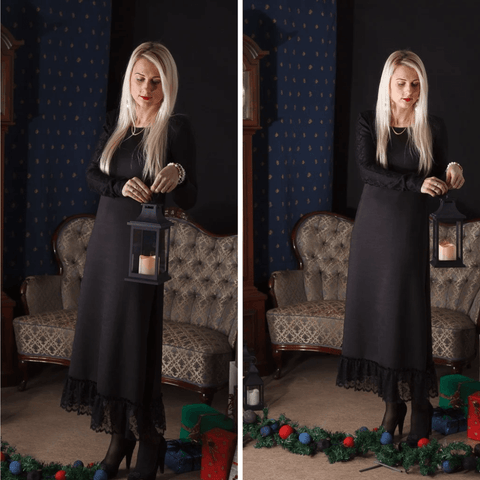 BETOLLI Winter Lady black maxi dress with long sleeves and a lace-trimmed hem, worn by a model holding a lantern.